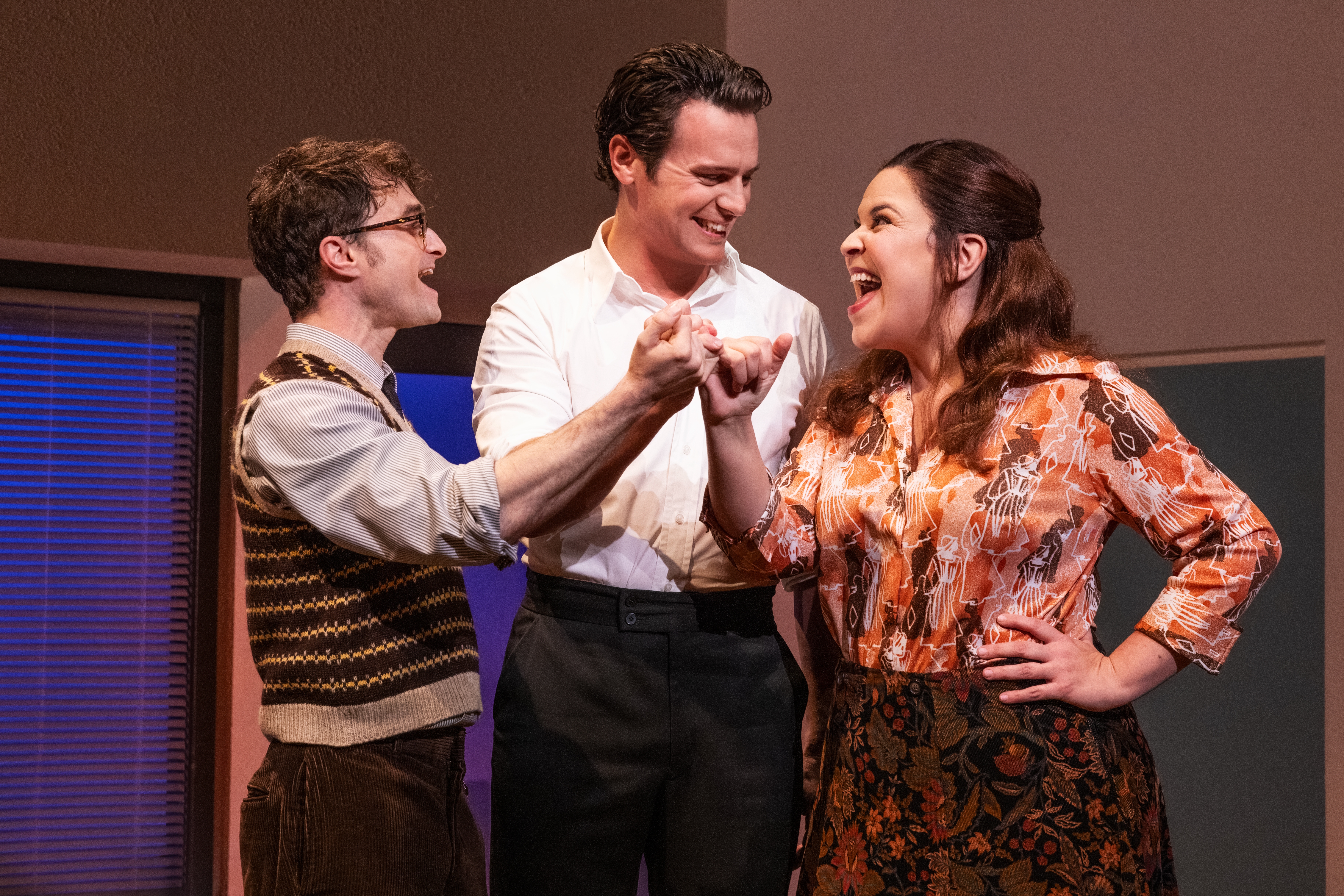 Daniel Radcliffe as Charley Kringas, Jonathan Groff as Franklin Shepard and Lindsay Mendez as Mary Flynn in <em>Merrily We Roll Along</em>, the Stephen Sondheim musical filmed on Broadway and now in theaters.